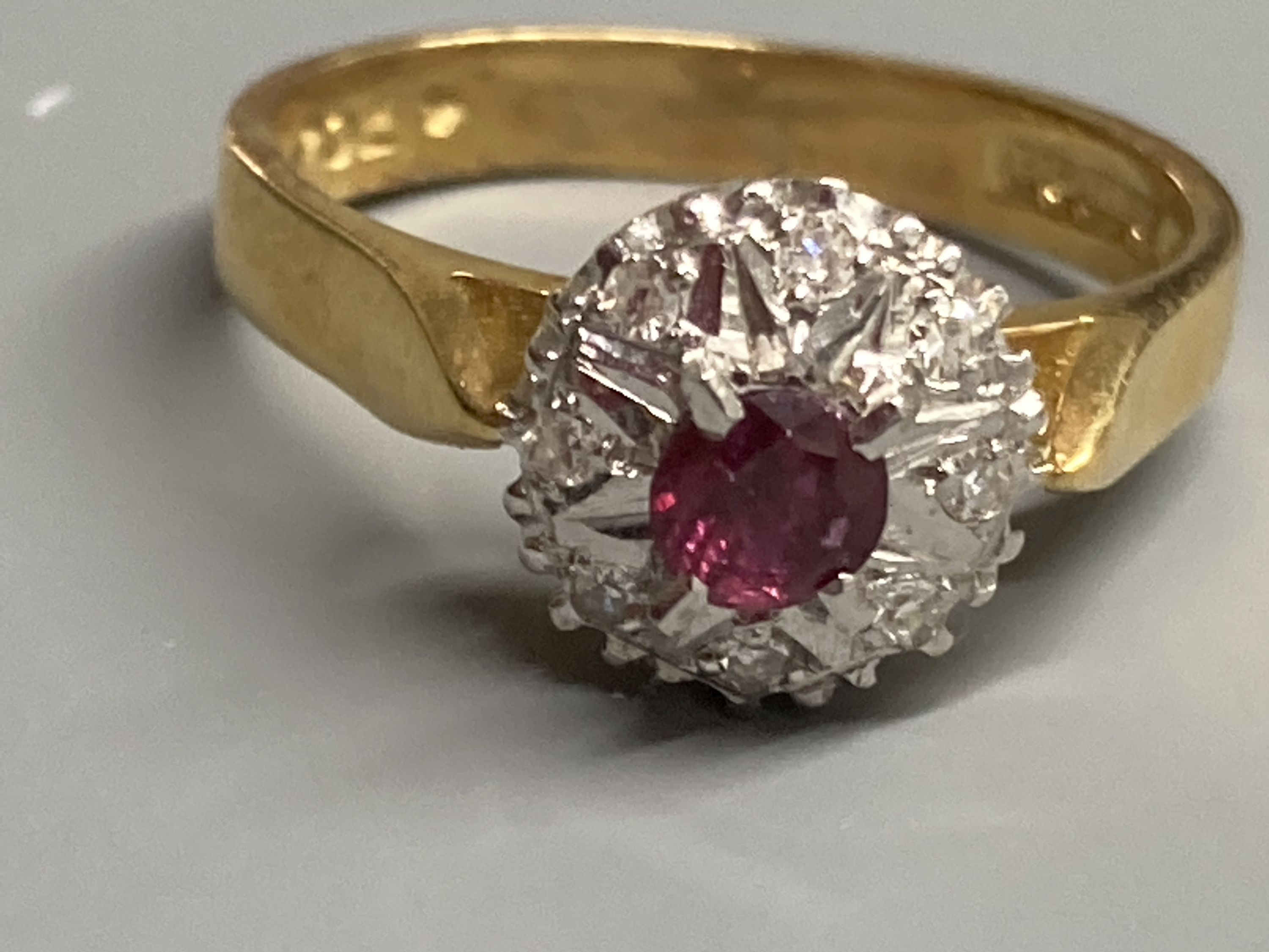 A modern 18ct gold, ruby and diamond chip set cluster ring, size M, gross 4.4 grams.